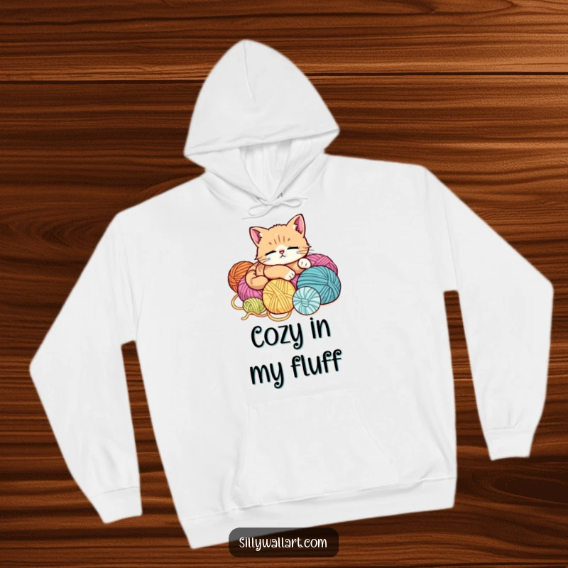 Funny hoodie featuring a cute, ultra-relaxed cat lounging on a massive pile of yarn balls, embodying ultimate comfort and laziness.