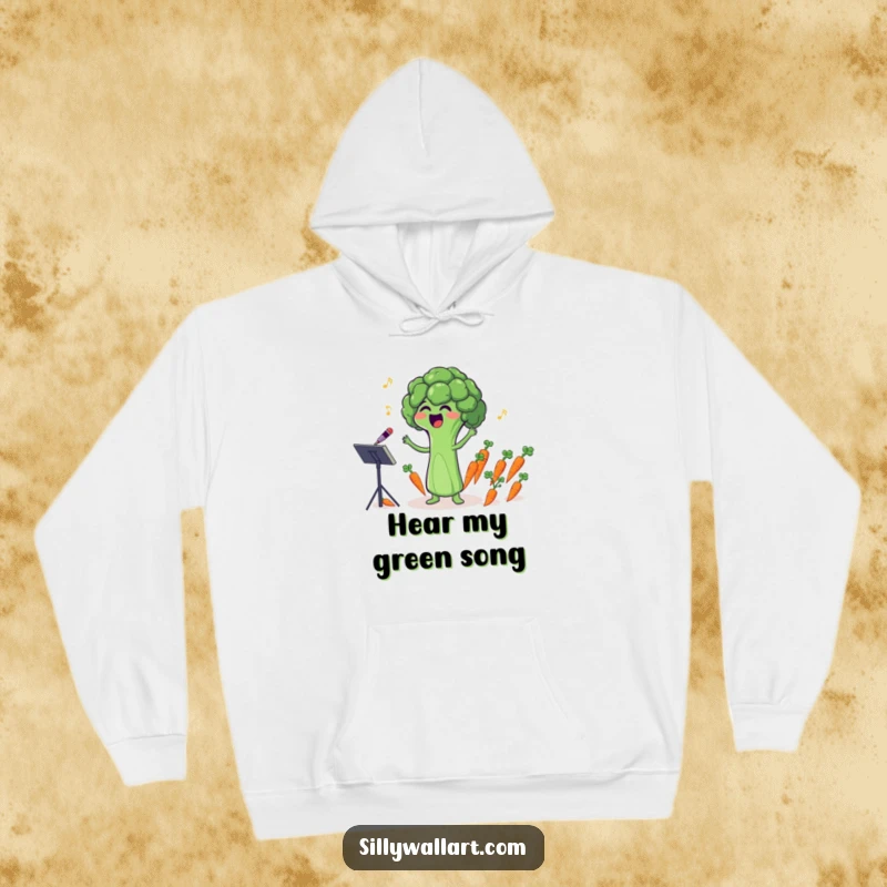 Funny hoodie depicting a singing broccoli floret comically conducting a tiny carrot orchestra, soft and humorous.