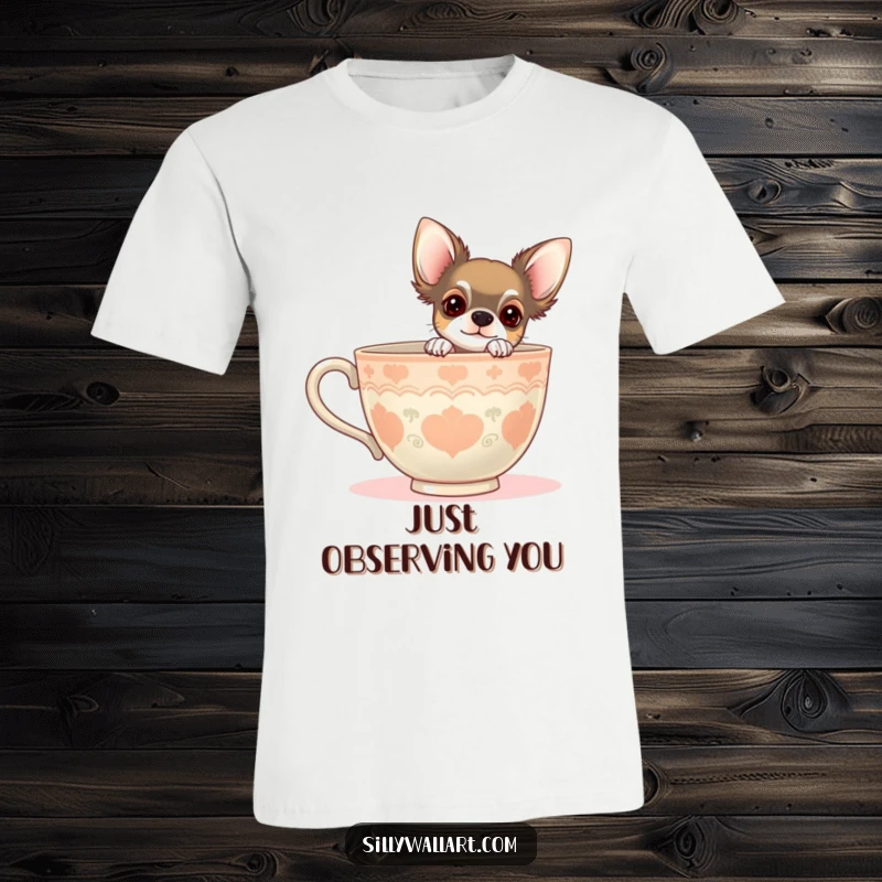 Funny t-shirt with a chihuahua peeking curiously from behind a giant teacup. Charming and humorous dog-themed apparel.